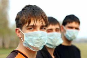 Three teenagers wearing hospital masks flu influenza healthmap social media twitter digital epidemiology digital disease detection